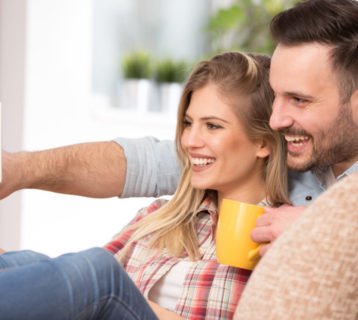Young couple looking at tablet at home