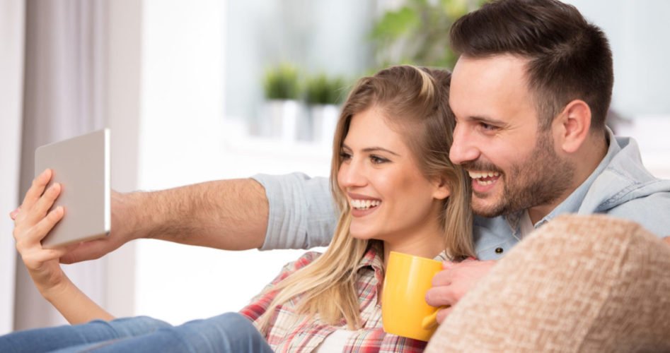 Young couple looking at tablet at home